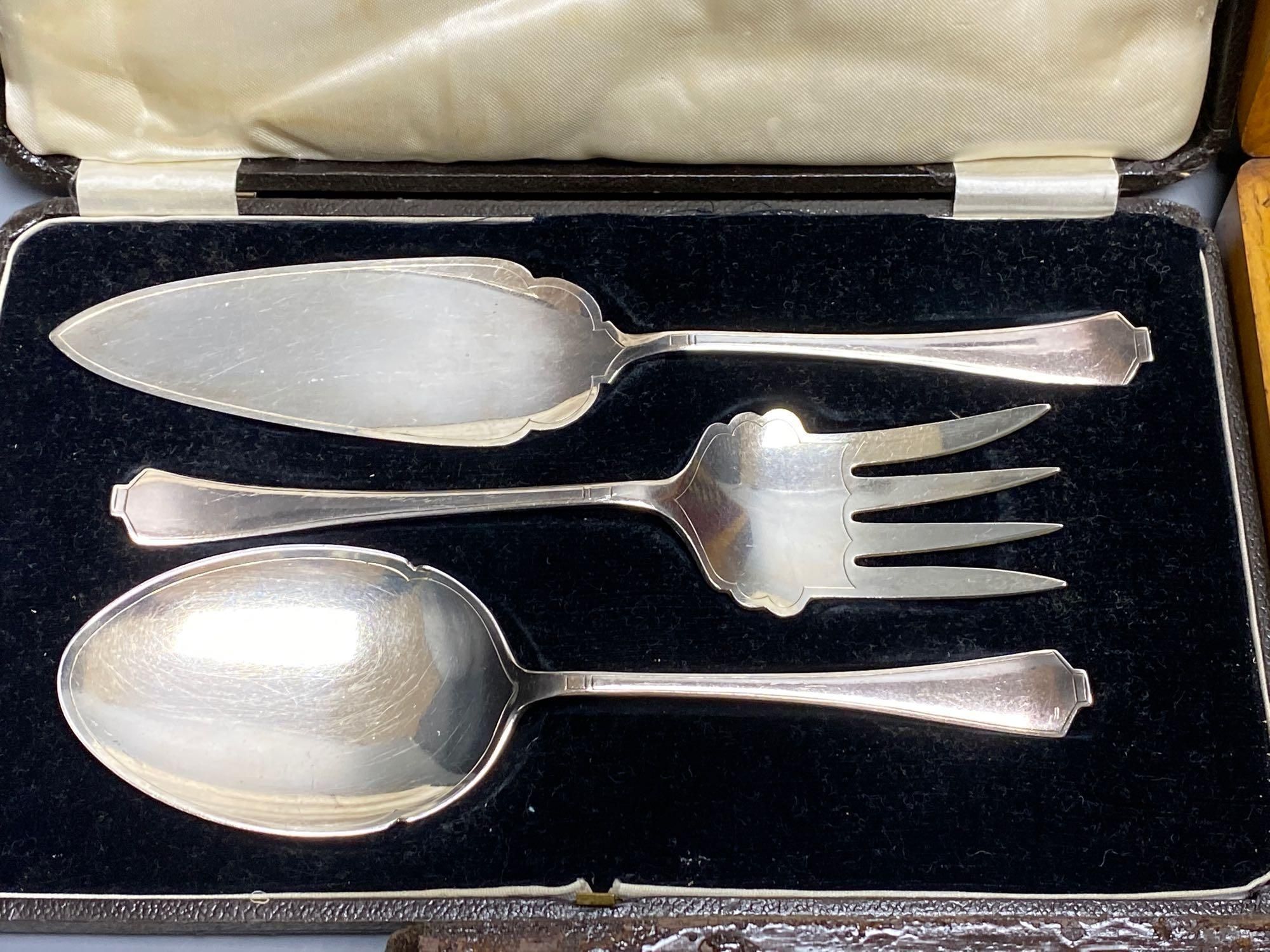 A Victorian rosewood cased set of eighteen plated dessert knives and forks, and two other cased sets of plated cutlery